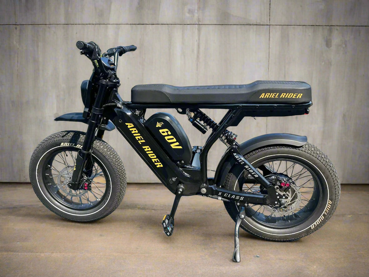 Black electric bike with 'Ariel Rider' branding on a paved surface.