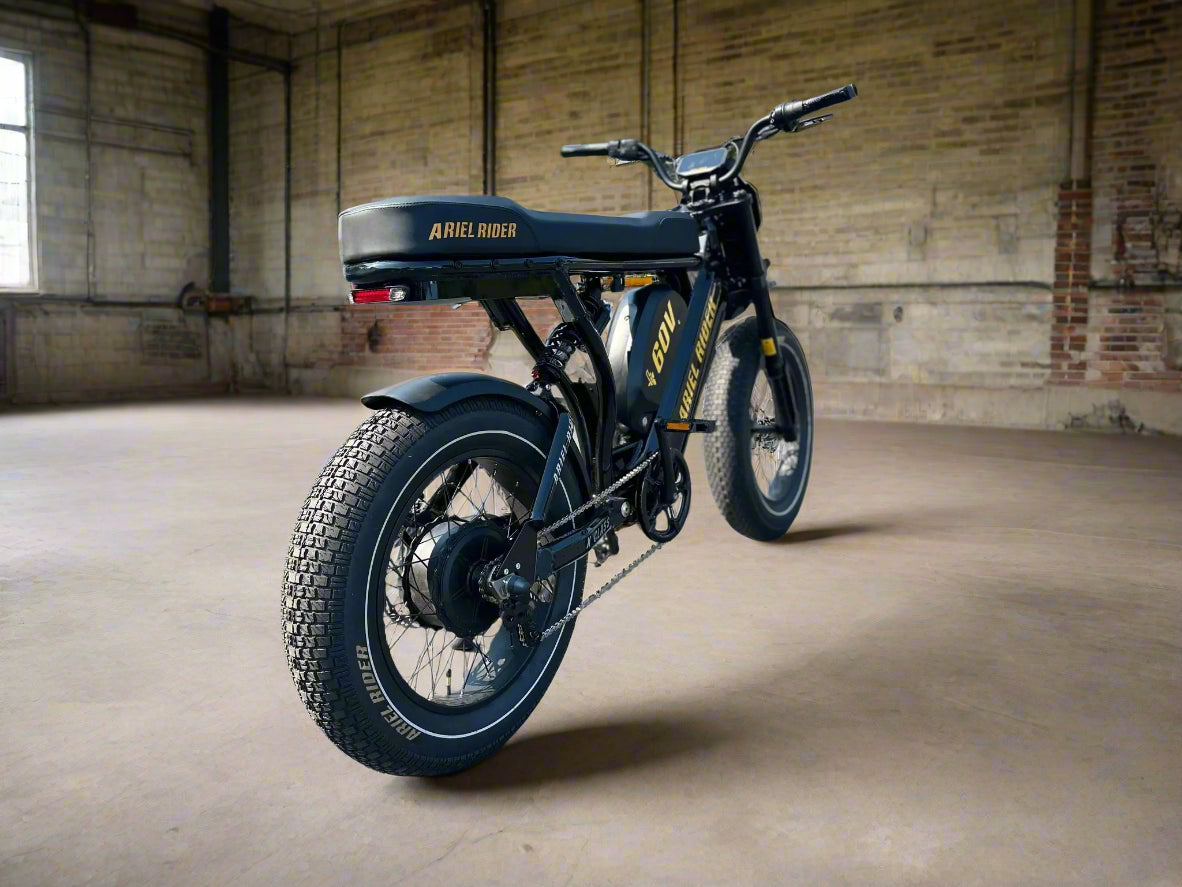 Black electric bike with visible branding on a paved surface.