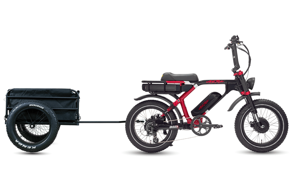 Ariel Rider Grizzly in red and black towing the cargo trailer, side view.