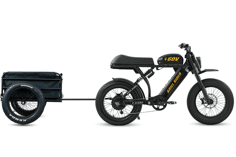 Ariel Rider X-Class 60V in black and yellow towing the cargo trailer, side view.