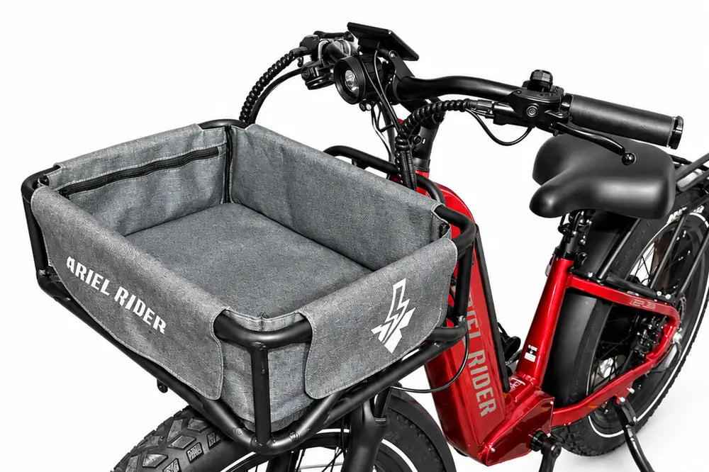 Ariel Rider front rack, black cargo basket and gray liner mounted on a red Kepler, three-quarter view.