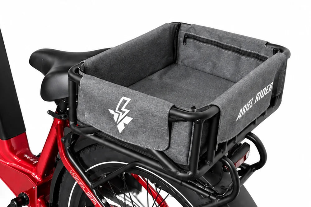 Angled view into the Ariel Rider rear cargo basket liner, showing its gray interior and zippered pocket.