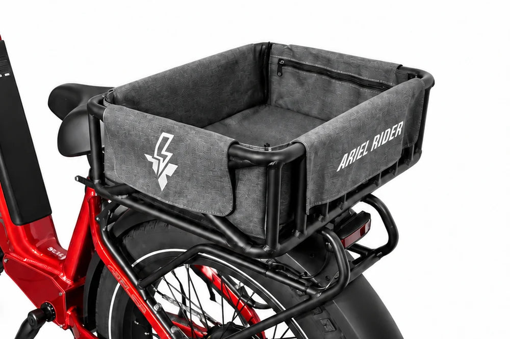 Rear detail of the Ariel Rider cargo basket and fitted gray liner above the rear wheel of a red Kepler.