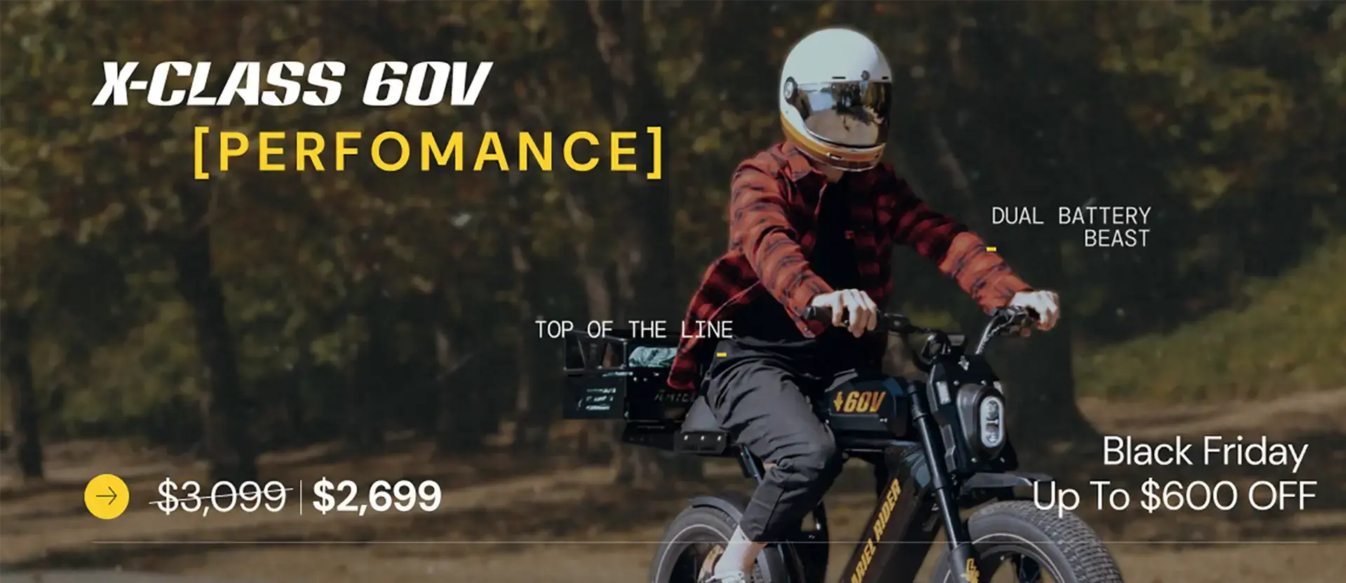 A rider on the Ariel Rider X-Class 60V Performance electric bike during fall, showing the dual-battery setup and Black Friday sale messaging.
