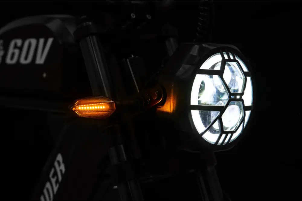 Motorcycle headlight and turn signal on a dark background #Version_Cafe Racer