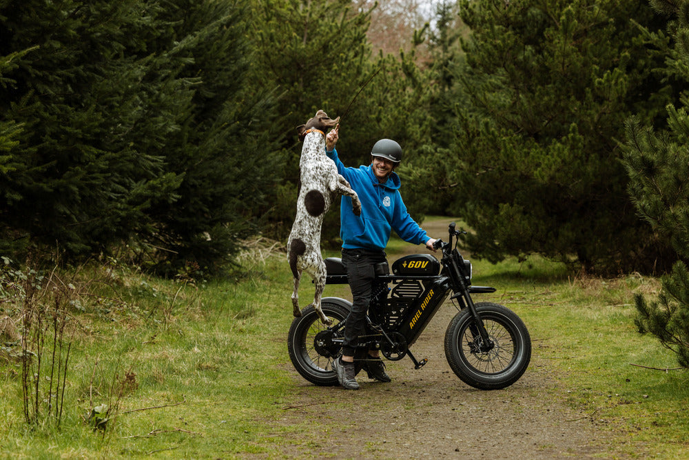 Ariel Rider X-Class 60V fat tire ebike climbing a steep urban hill — 60V torque and wide puncture-resistant tires delivering real 1000W performance feel.