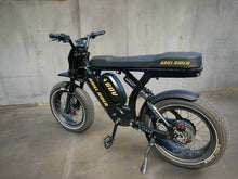 Load image into Gallery viewer, Black electric bike with &#39;Ariel Rider&#39; branding on a paved surface.
