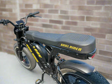 Load image into Gallery viewer, Black electric bike with &#39;Ariel Rider&#39; branding on a paved road.