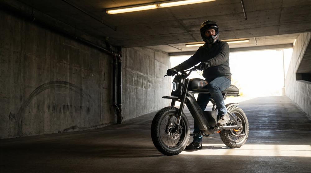 Rider on an Ariel Rider Power Performance Bike in an off-road setting