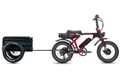 Ariel Rider Grizzly in red and black towing the cargo trailer, side view.