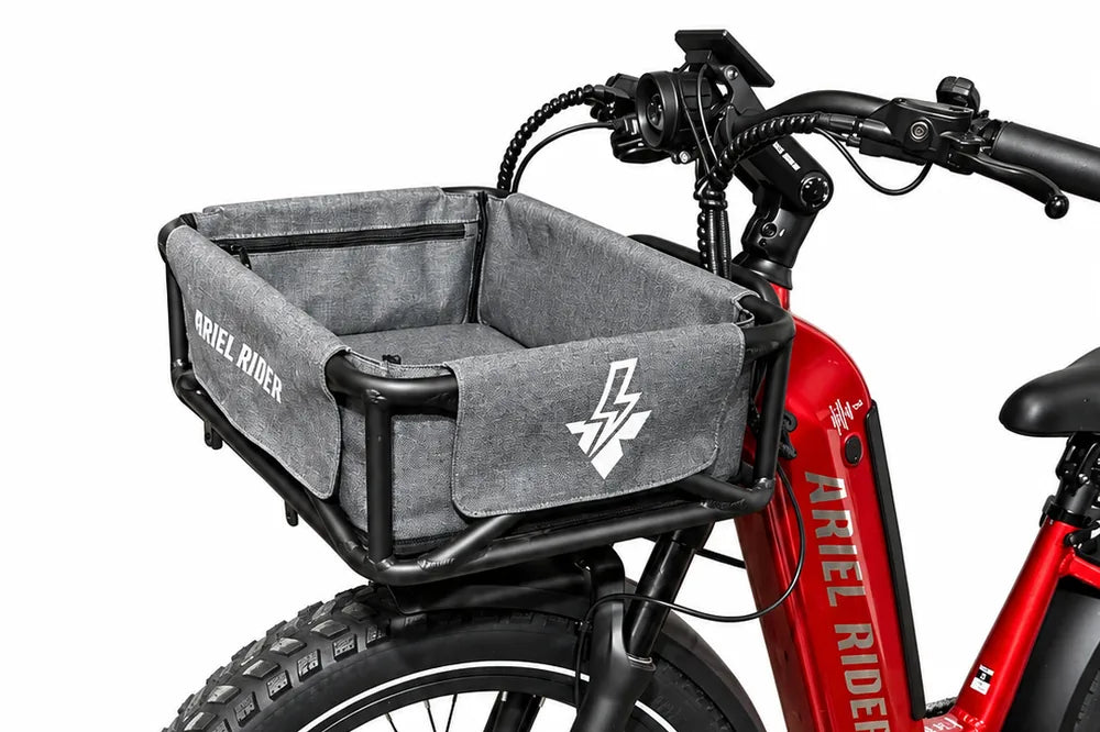 Side view of the Ariel Rider front cargo basket and gray liner above the front wheel of a red Kepler.