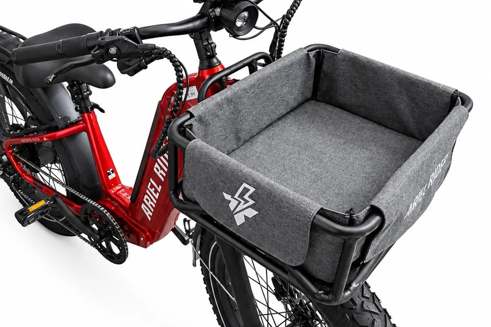 Angled top view of the gray liner inside an Ariel Rider front cargo basket, showing the open interior.