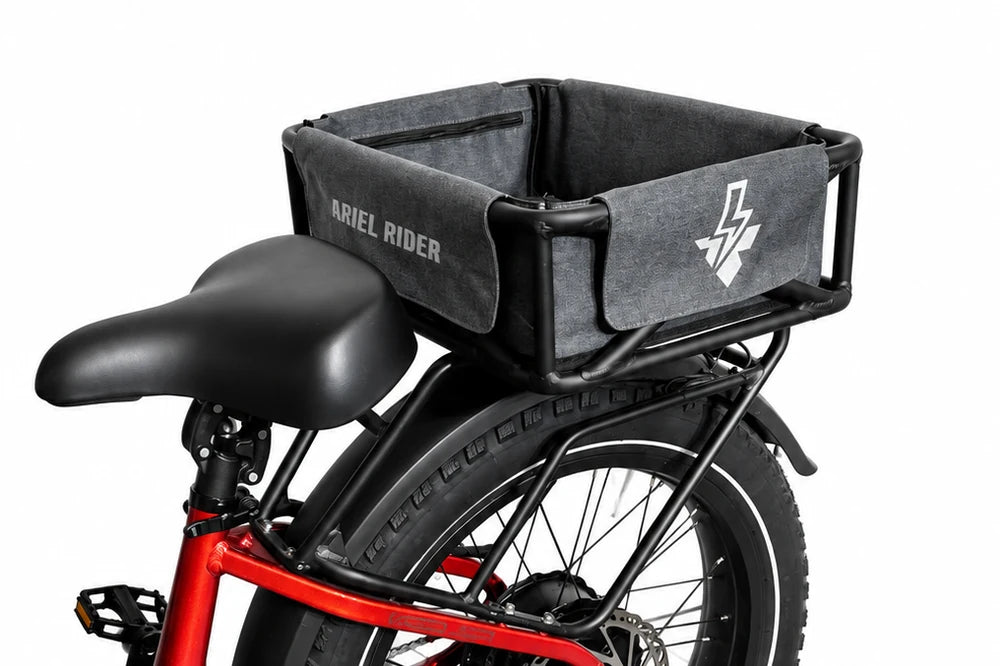 Ariel Rider cargo basket and gray liner mounted on a red Kepler, with the rear rack and saddle visible.
