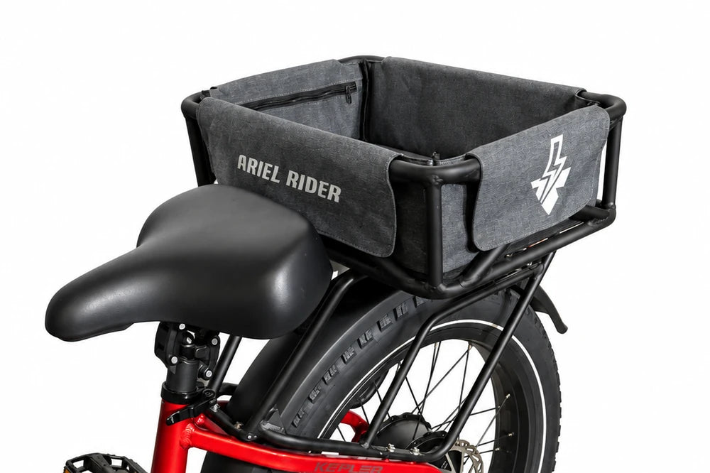 Ariel Rider black cargo basket and gray liner mounted behind the saddle on a red Kepler rear rack.