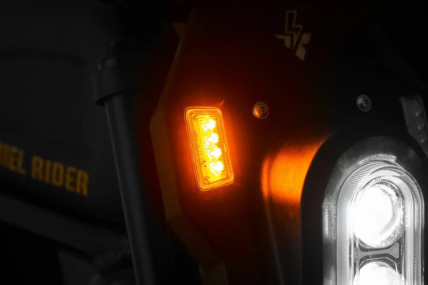 Front amber LED turn signal light on the Ariel Rider X-Class 60V e-bike for safer urban riding.