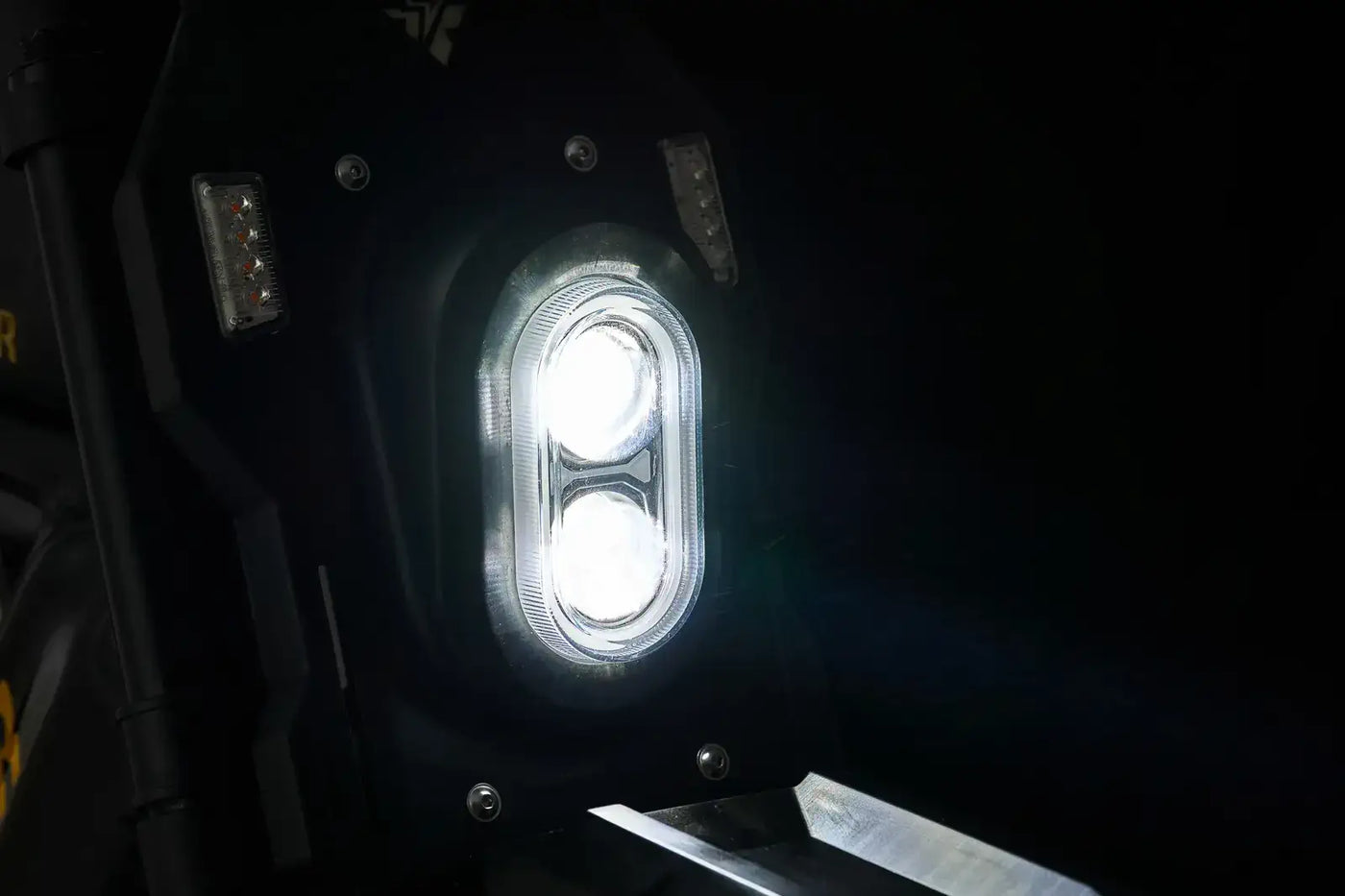 Dual LED headlight on the Ariel Rider X-Class 60V fat tire electric bike for enhanced night visibility.