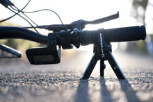 Load image into Gallery viewer, Portable Handlebar Jack supporting an e-bike during roadside repairs, protecting sensitive handlebar-mounted electronics.