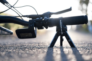 Portable Handlebar Jack supporting an e-bike during roadside repairs, protecting sensitive handlebar-mounted electronics.